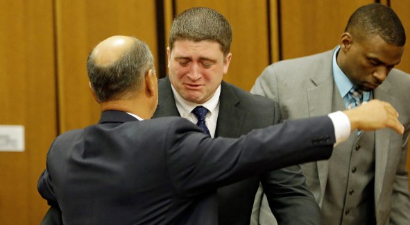 Michael Brelo hugs his attorney, Patrick D’Angelo, after the verdict in his trial Saturday, May 23, 2015, in Cleveland. Brelo, a patrolman charged in the shooting deaths of two unarmed suspects during a 137-shot barrage of gunfire was acquitted Saturday in a case that helped prompt the U.S. Department of Justice determine the city police department had a history of using excessive force and violating civil rights. (AP Photo/Tony Dejak)