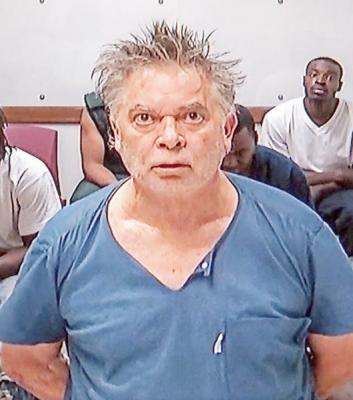 Rick Danzl/The News-Gazette David Farrell appears on a monitor during his arraignment at the Champaign County Courthouse in Urbana Monday June 13, 2016 for shooting/killing his son Matthew Farrell.