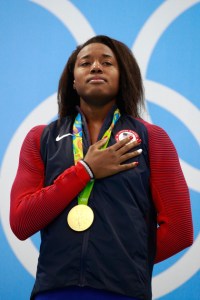 RIO DE JANEIRO, BRAZIL - AUGUST 11: Gold medalist Simone Manuel of the United States celebrates on the podium during the medal ceremony for the Women's 100m Freestyle Final on Day 6 of the Rio 2016 Olympic Games at the Olympic Aquatics Stadium on August 11, 2016 in Rio de Janeiro, Brazil. (Photo by Adam Pretty/Getty Images)